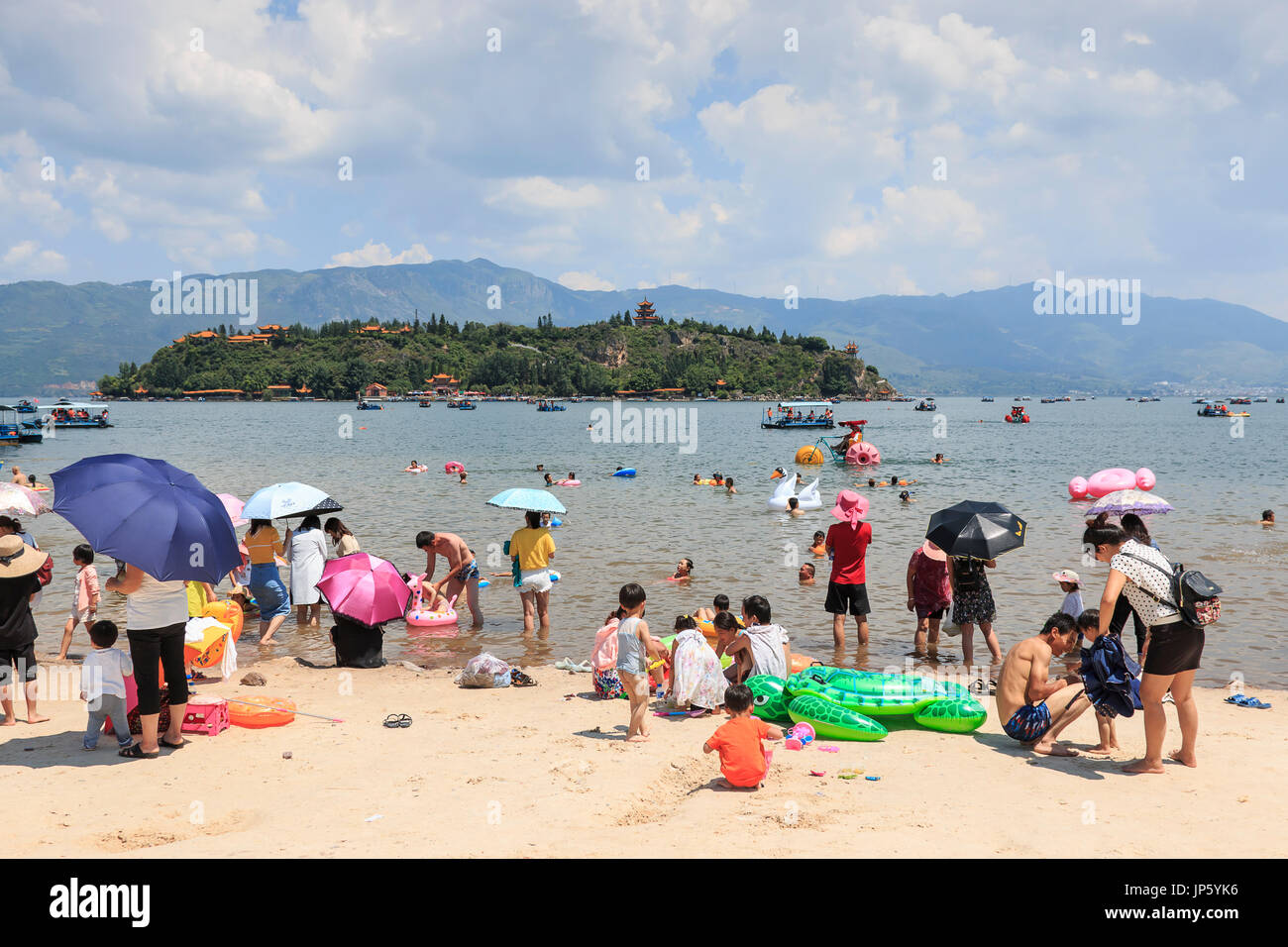 Yuxi, China July 29, 2017 Chinese tourists on a beach of the Fuxian