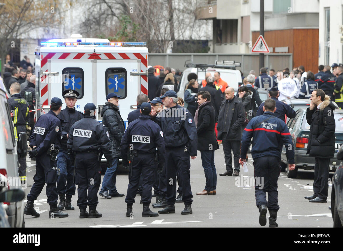 PARIS, France - Police officers inspect the crime scene where at least
