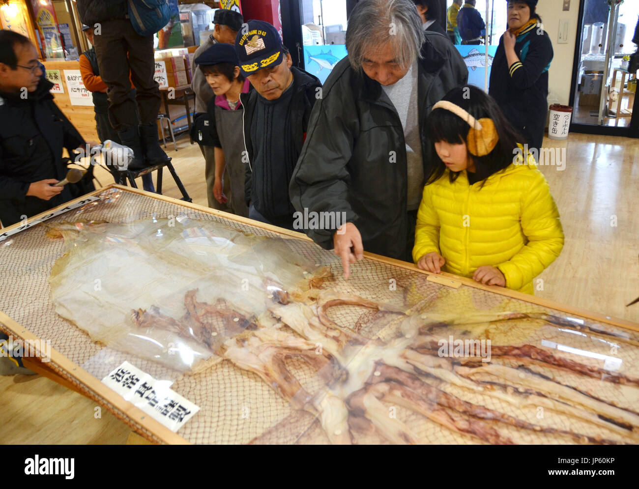 TOKYO, Japan Visitors look at a dried giant squid at a shopping mall