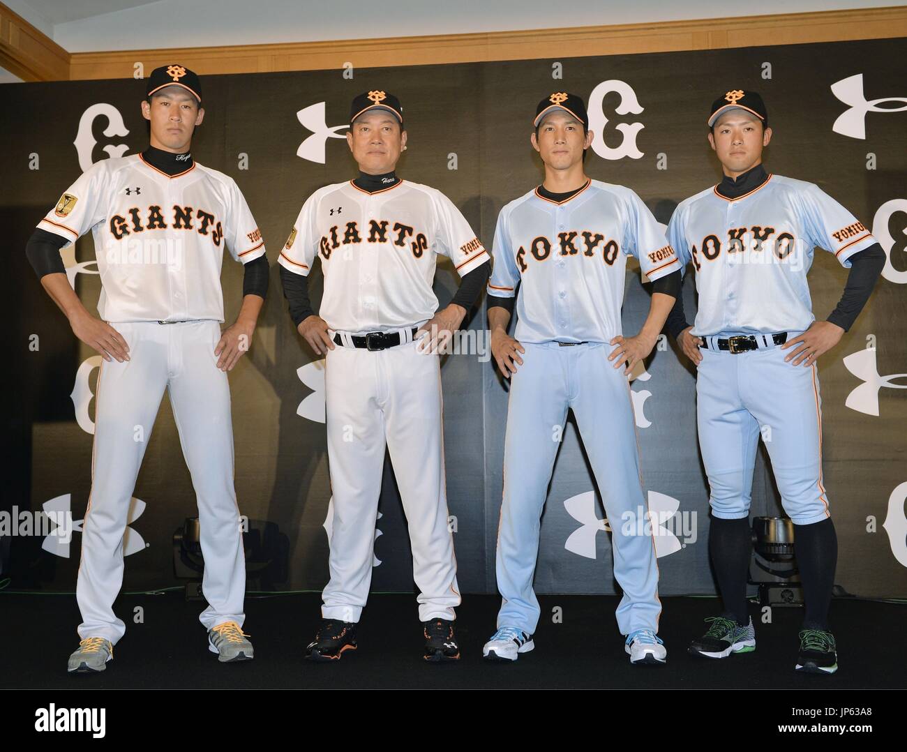 TOKYO, Japan - Yomiuri Giants manager Tatsunori Hara (2nd from L) joins  players of his team in showing off the Japanese professional baseball  club's new uniforms in Tokyo on Dec. 22, 2014,