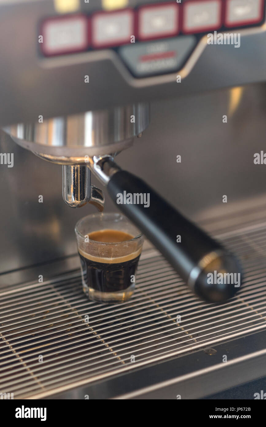 Espresso machine brewing hot espresso Stock Photo Alamy