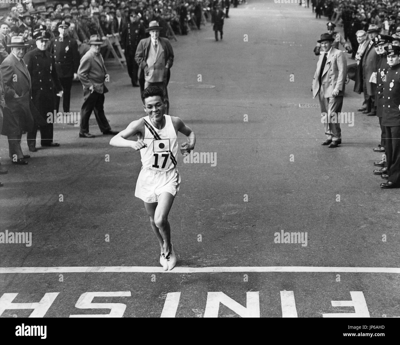 Shigeki Tanaka crosses the finish line to win the Boston Marathon in