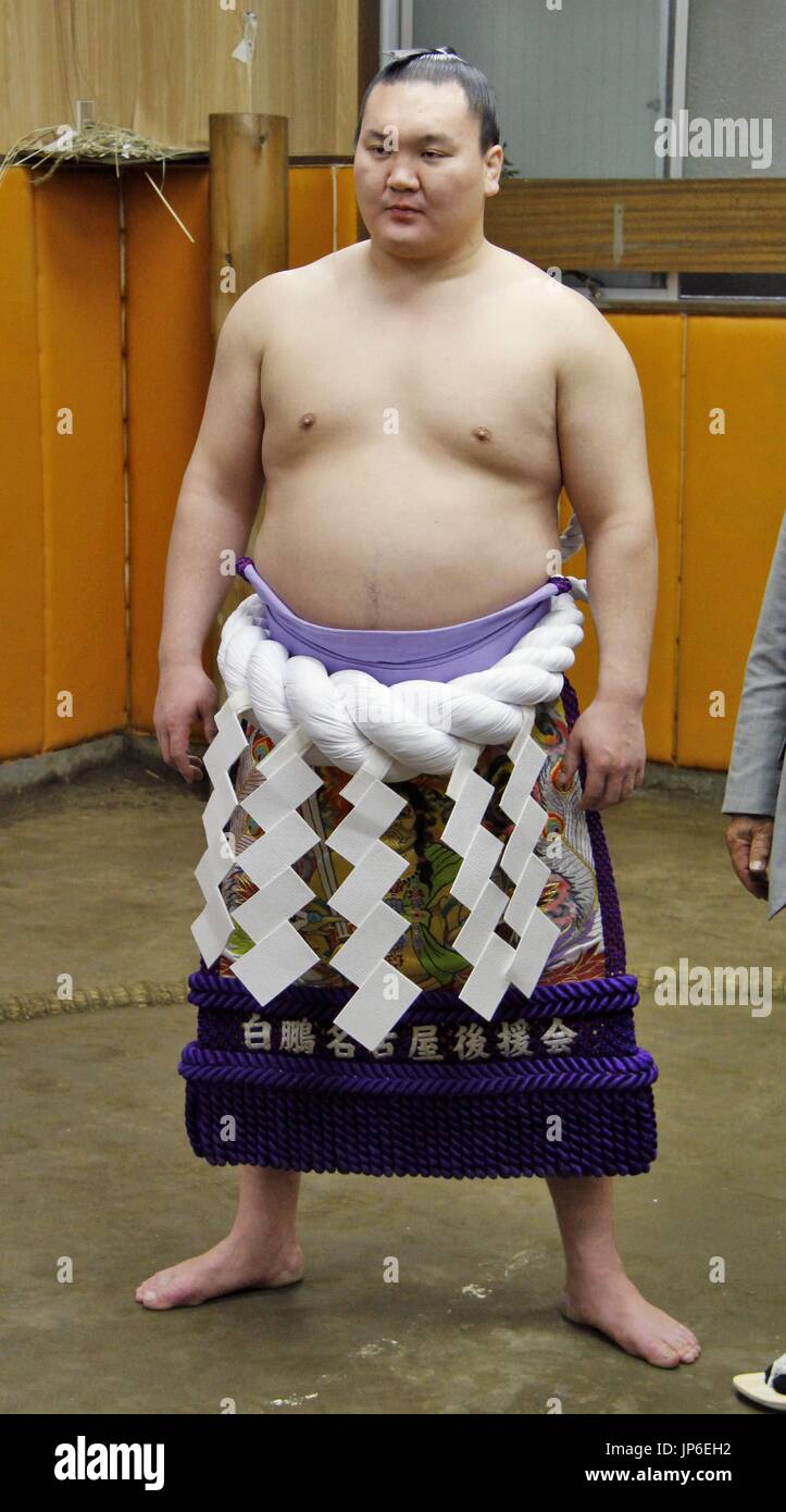 Yokozuna Hakuho wears a newly made rope for him at Miyagino Stable in
