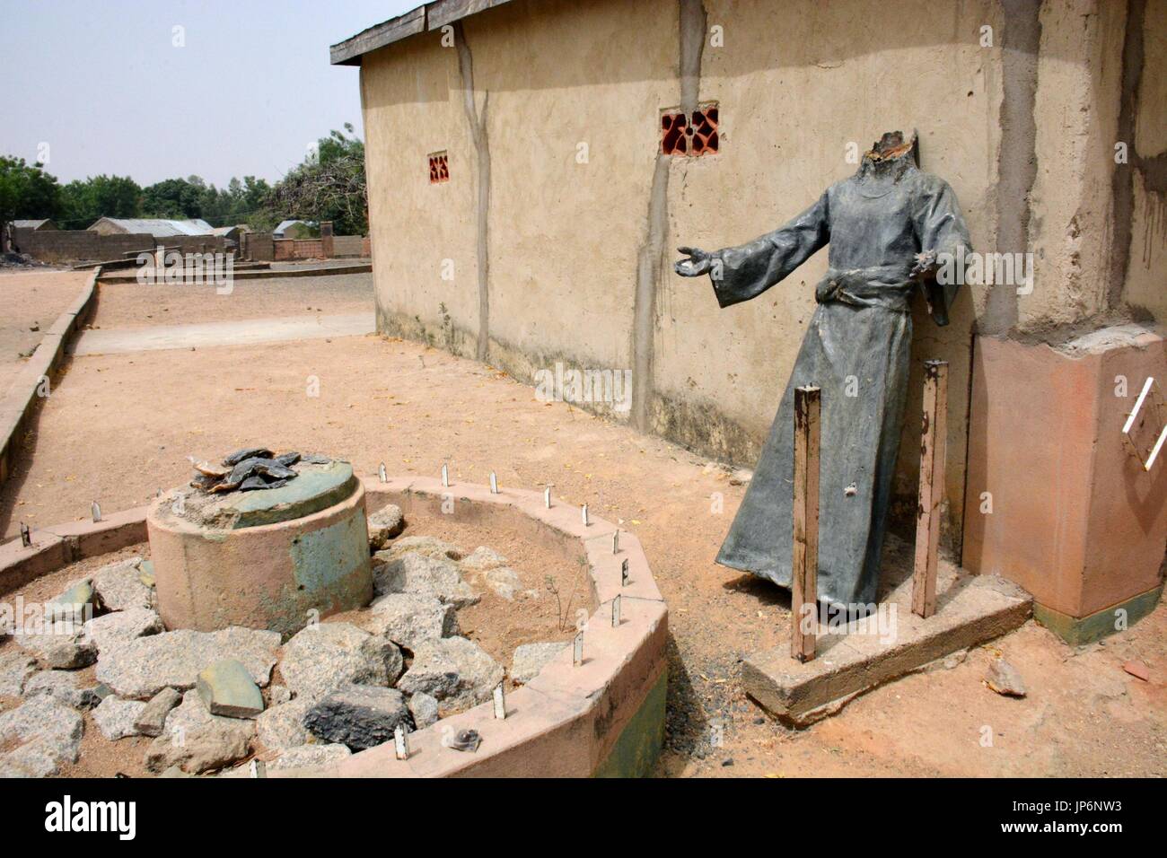 A headless statue of Christian missionary St. Patrick stands outside a
