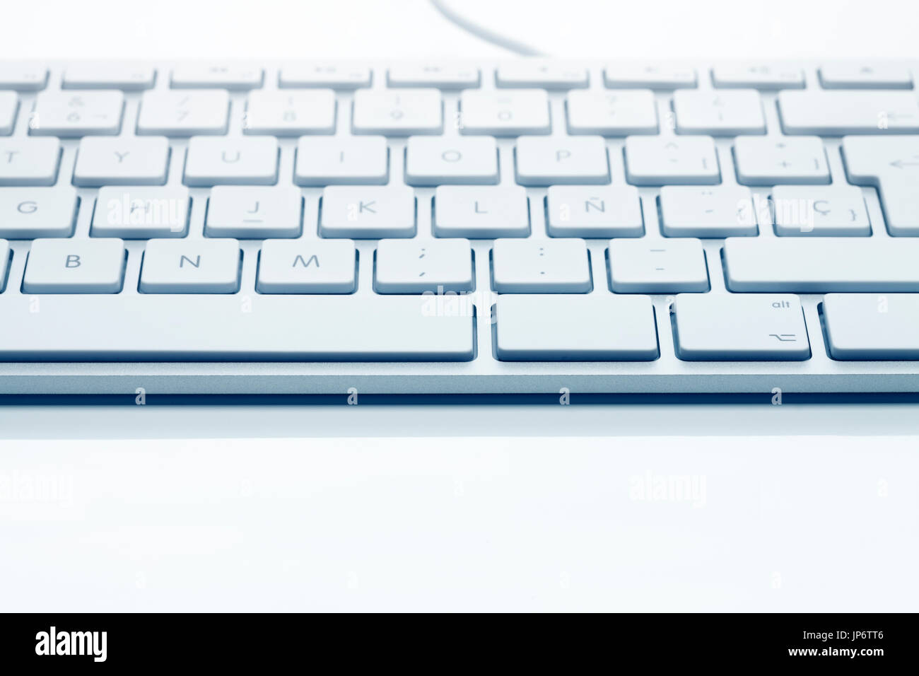 Close up front view of classical keyboard against white background. Shallow depth of field. Soft focus faded toward background. Stock Photo
