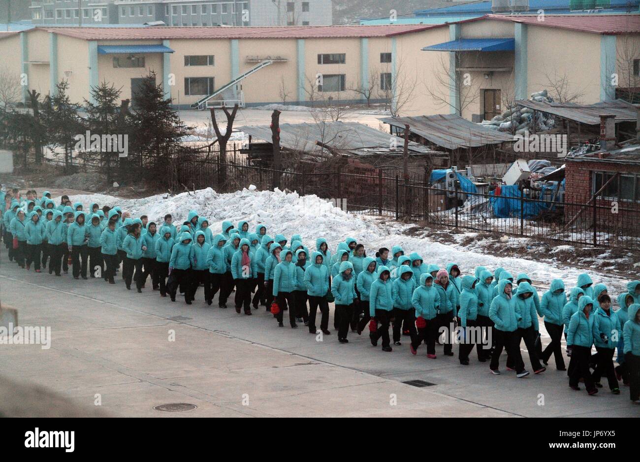 North Korean laborers form a long line on Jan. 11, 2015, as they head ...