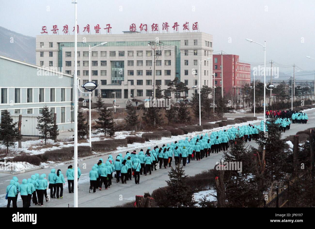 North Korean laborers form a long queue on Jan. 11, 2015, as they head ...