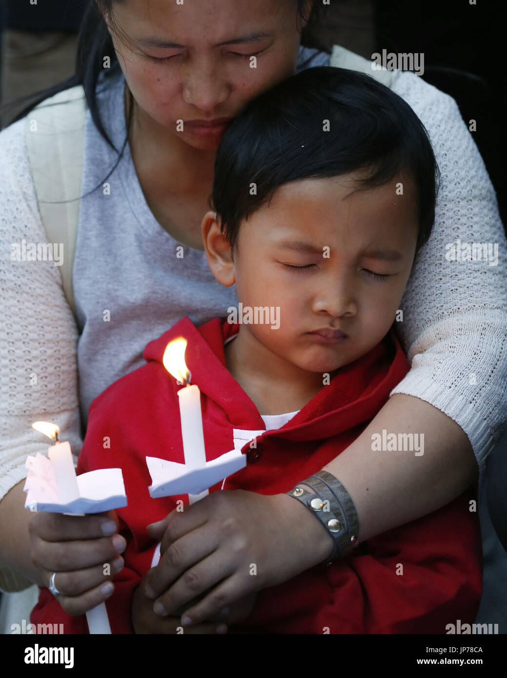 People light candles to pray for victims of a deadly earthquake in