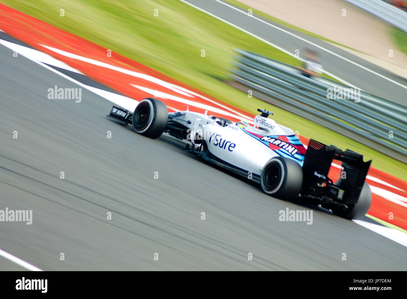 A Wiliams F1 car at the the first corner of the Silverstone Grand Prix circuit during the 2016 British Formula 1 Grand Prix Stock Photo