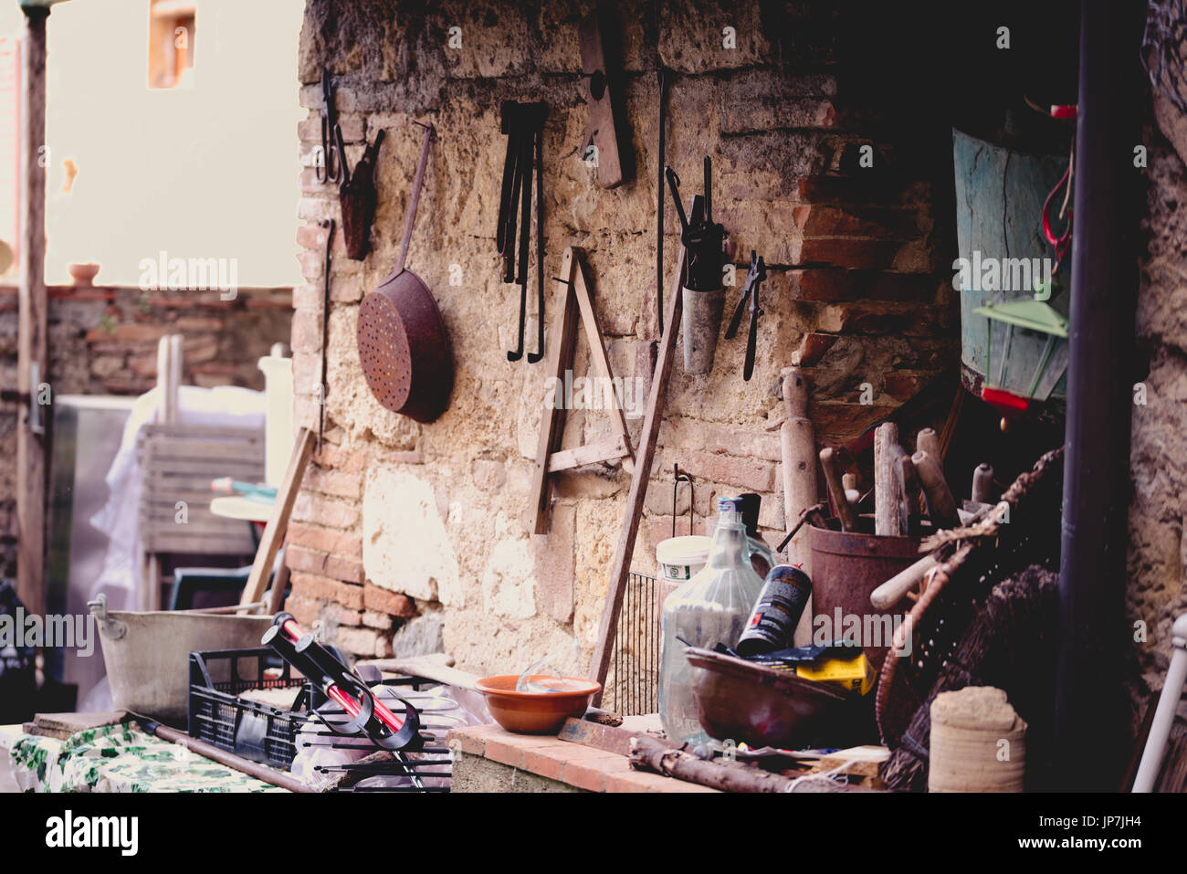Various rusty tools hanging on a wall Stock Photo