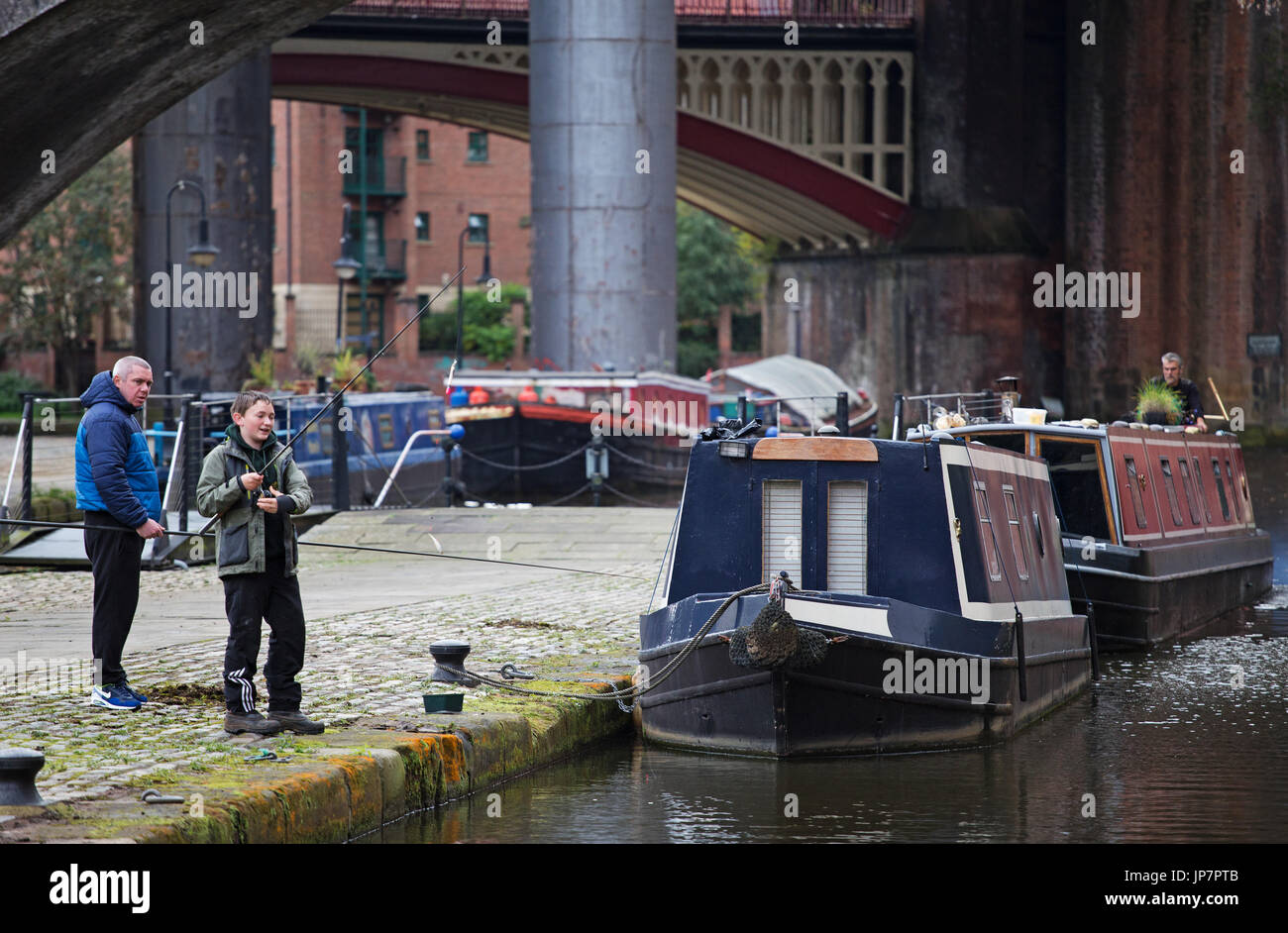 Young boy fishing on the Bridgewater Canal in Manchester Stock Photo