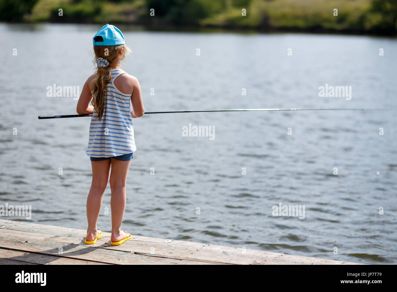 Girl fishing pole young sitting hi-res stock photography and images - Alamy