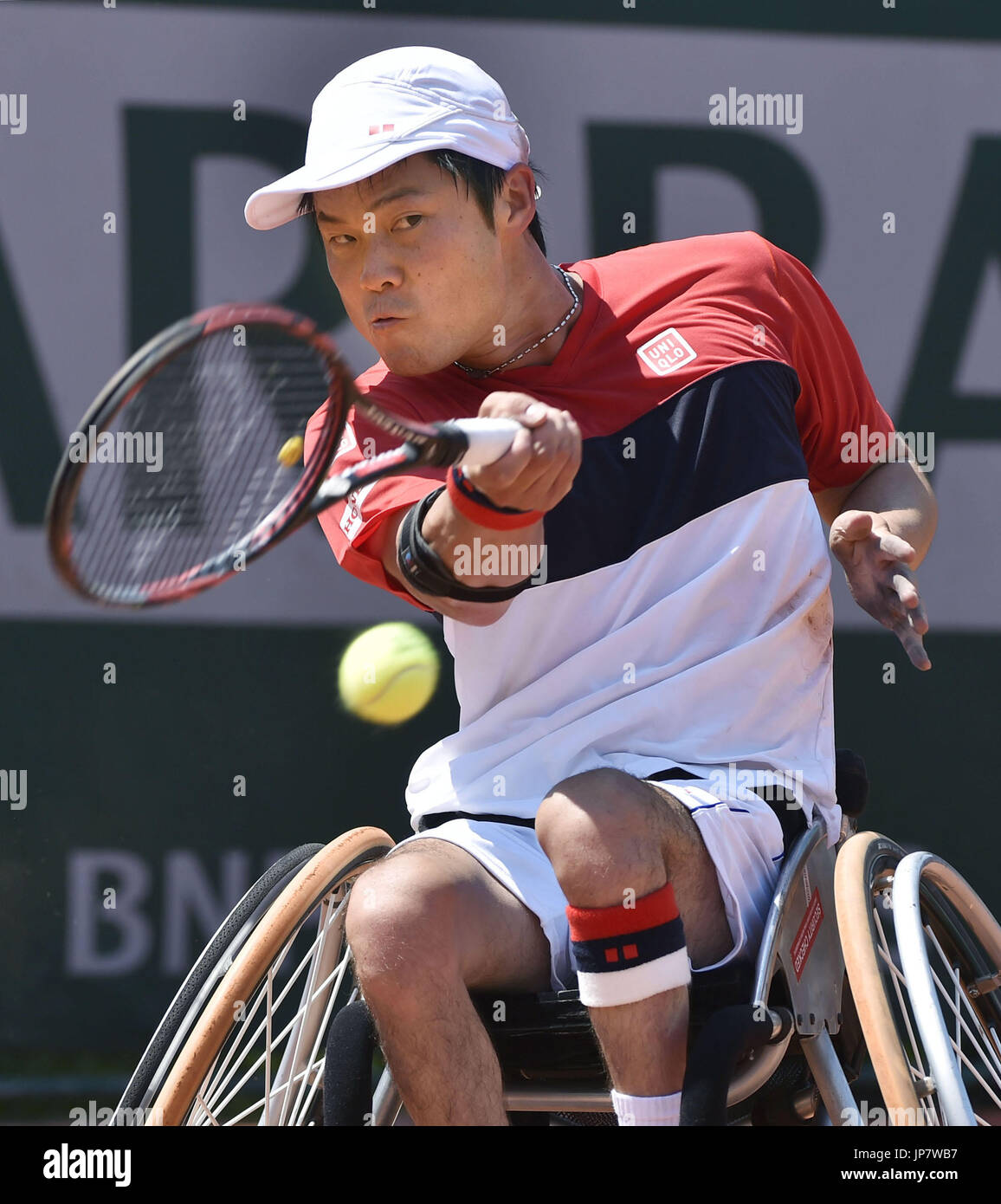 Japanese wheelchair tennis player Shingo Kunieda returns a serve during