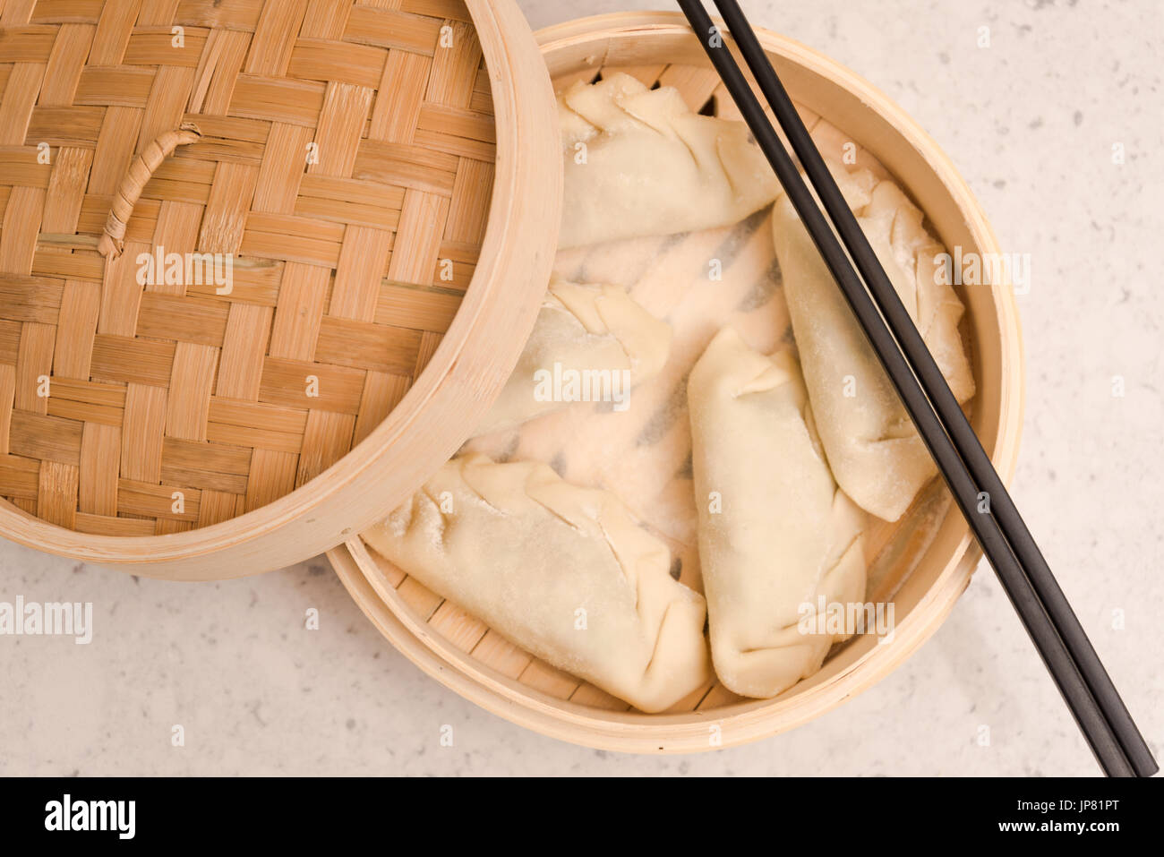 Dumpling in a Container before Steaming and a Pair of a Black