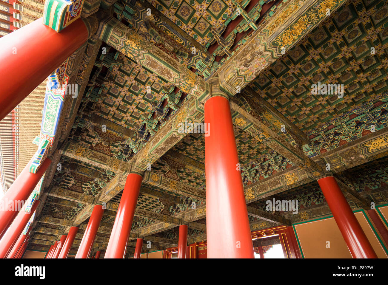 Red columns and intricate design of ceiling of Hall of Supreme Harmony in Forbidden City in Beijing Stock Photo