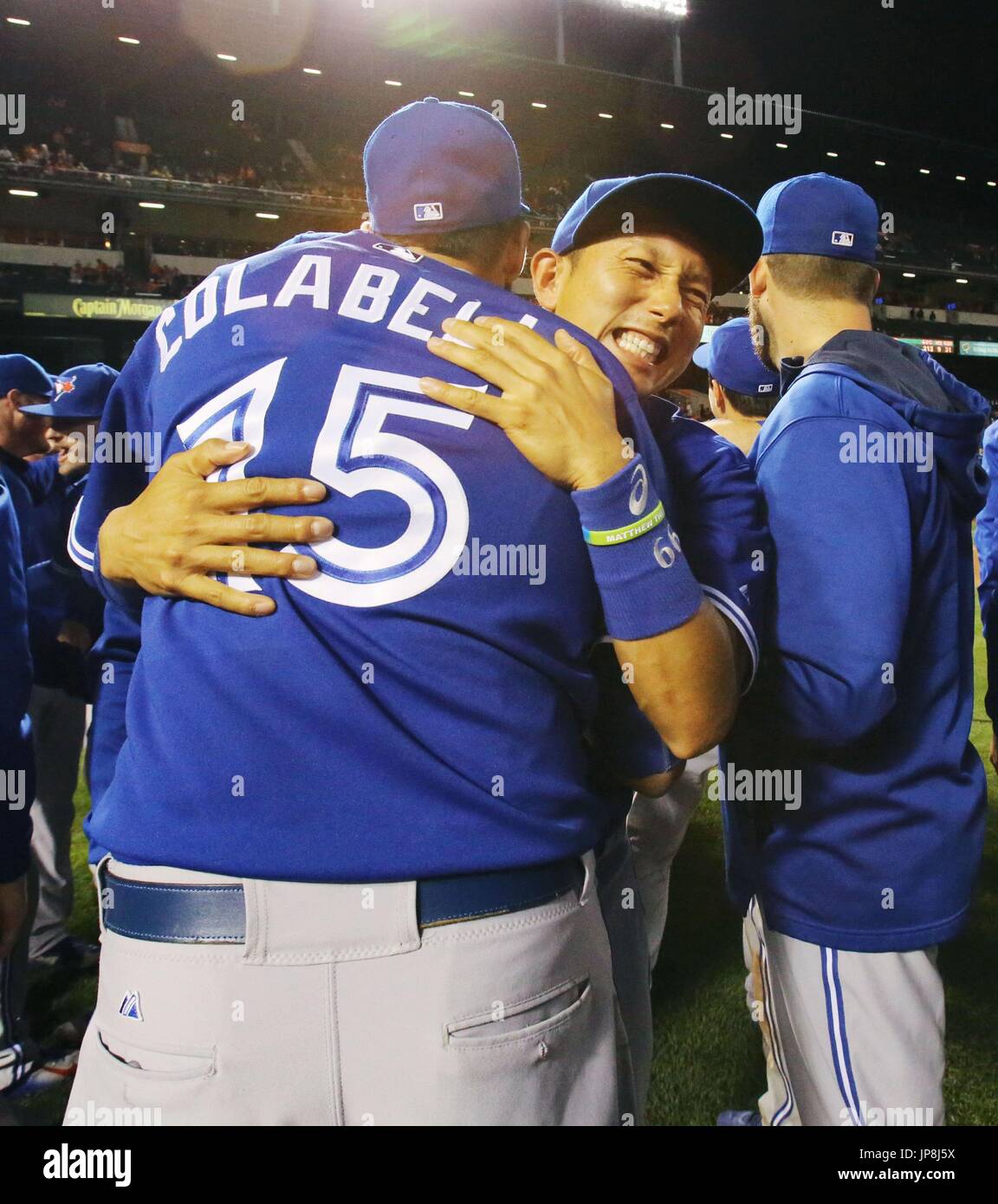 Toronto Blue Jays' Chris Colabello (15) hugs his teammate Munenori ...