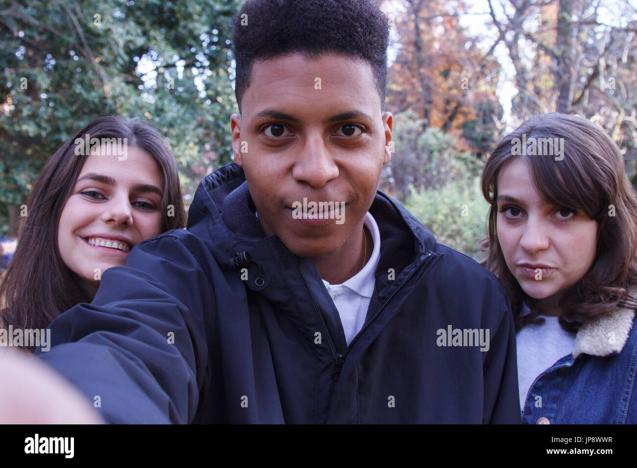 Young people of different races taking a selfie with the smartphone in ...