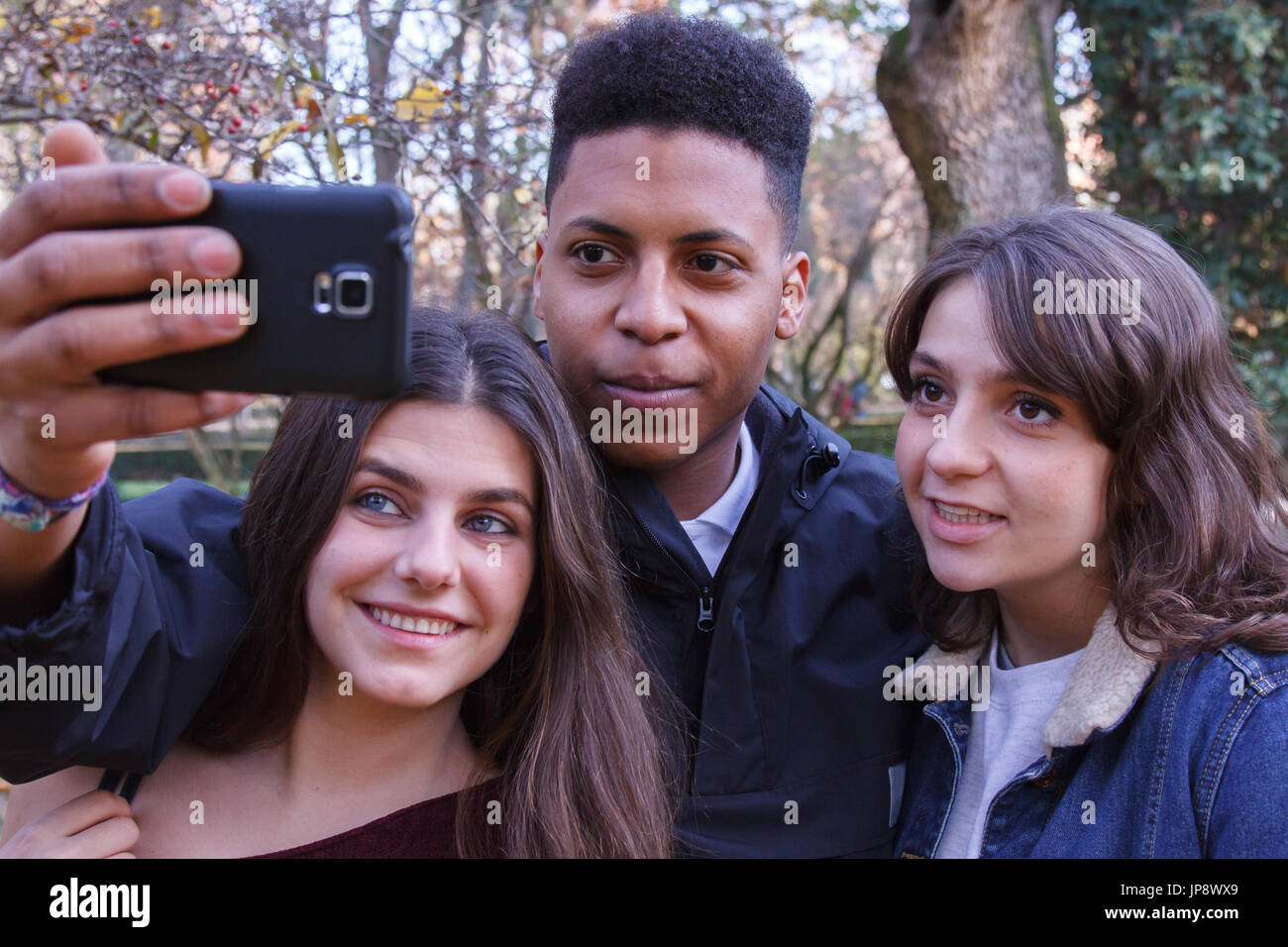Young people of different races taking a selfie with the smartphone in ...