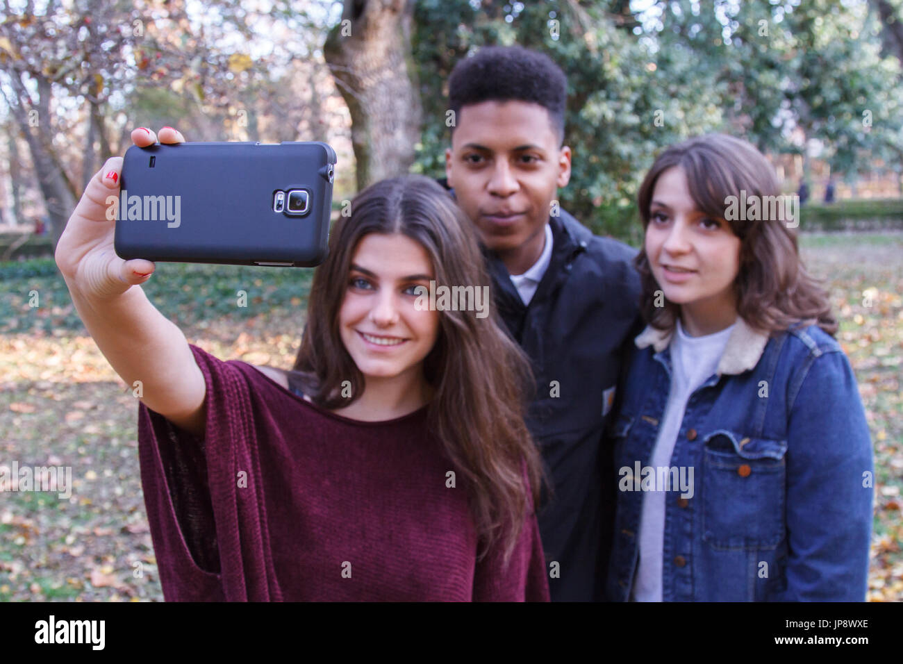 Young people of different races taking a selfie with the smartphone in ...