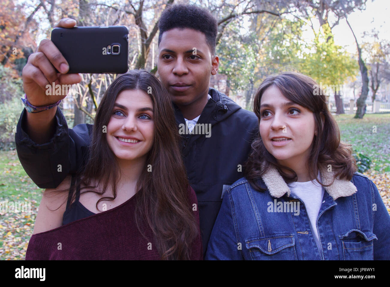 Young people of different races taking a selfie with the smartphone in ...