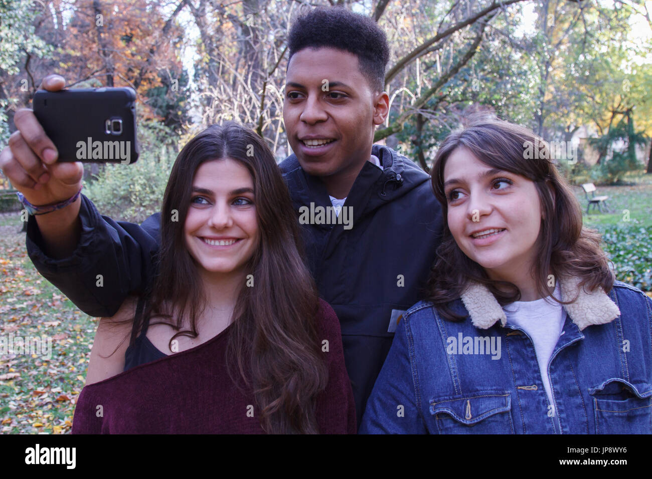 Young people of different races taking a selfie with the smartphone in ...