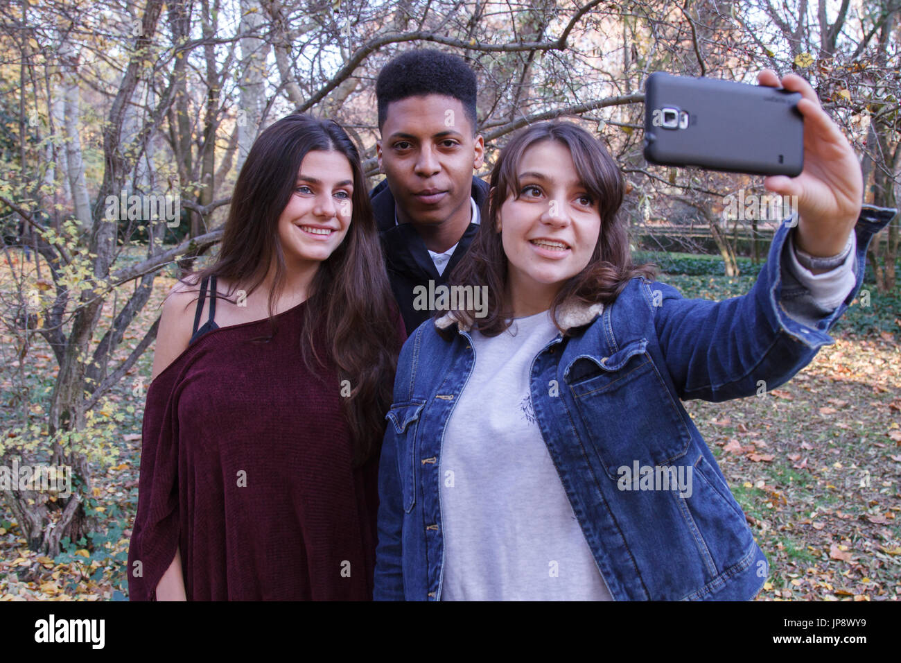 Young people of different races taking a selfie with the smartphone in ...