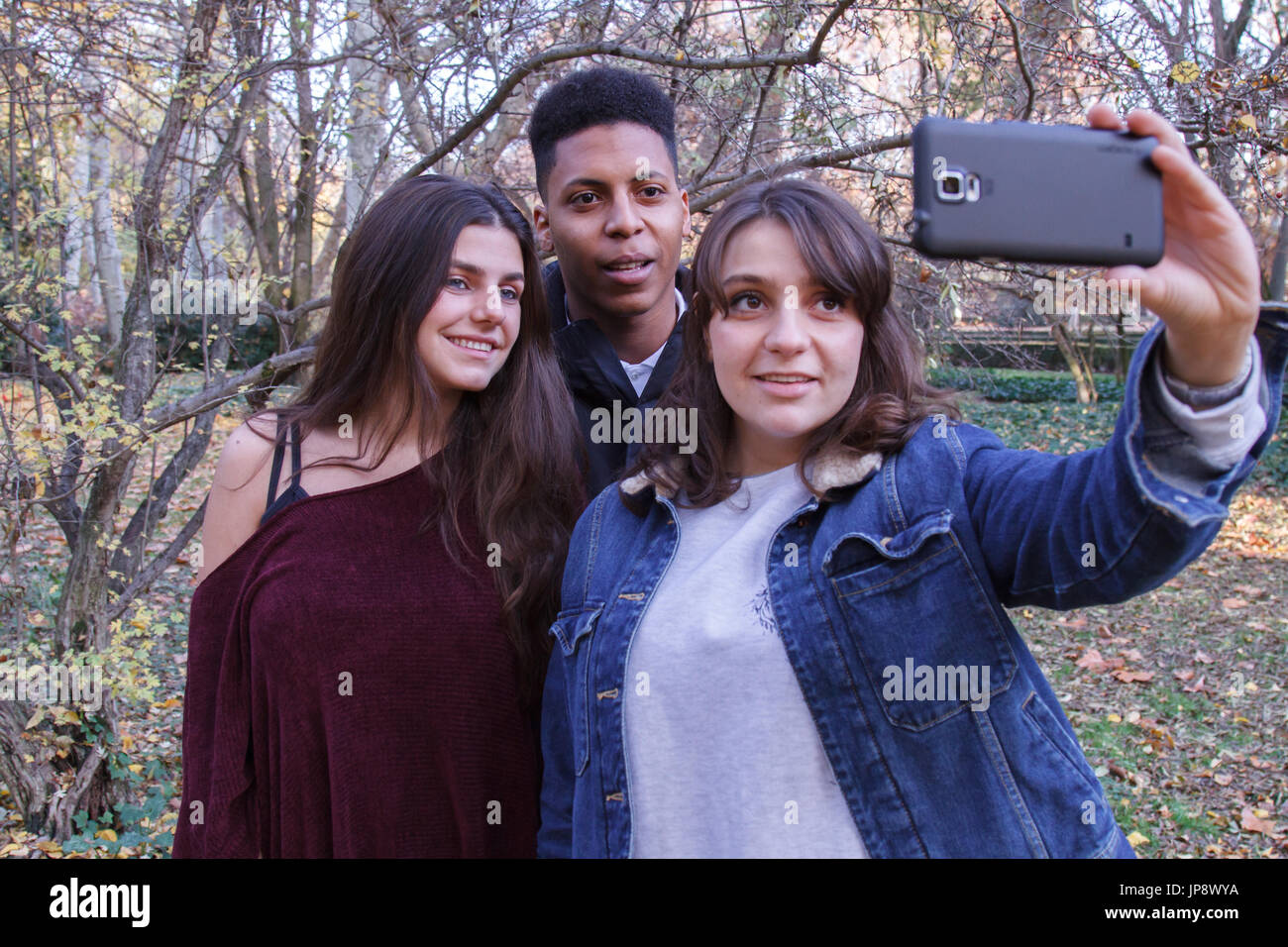 Young people of different races taking a selfie with the smartphone in ...