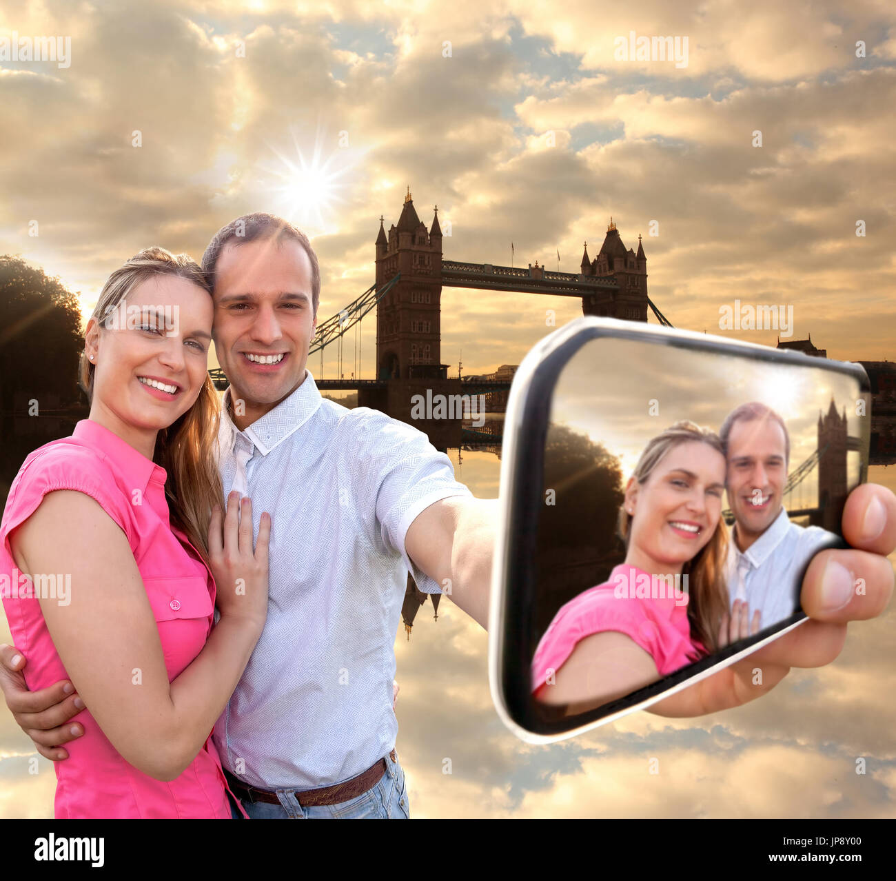 Tourist couple taking selfie against Tower Bridge in London, England