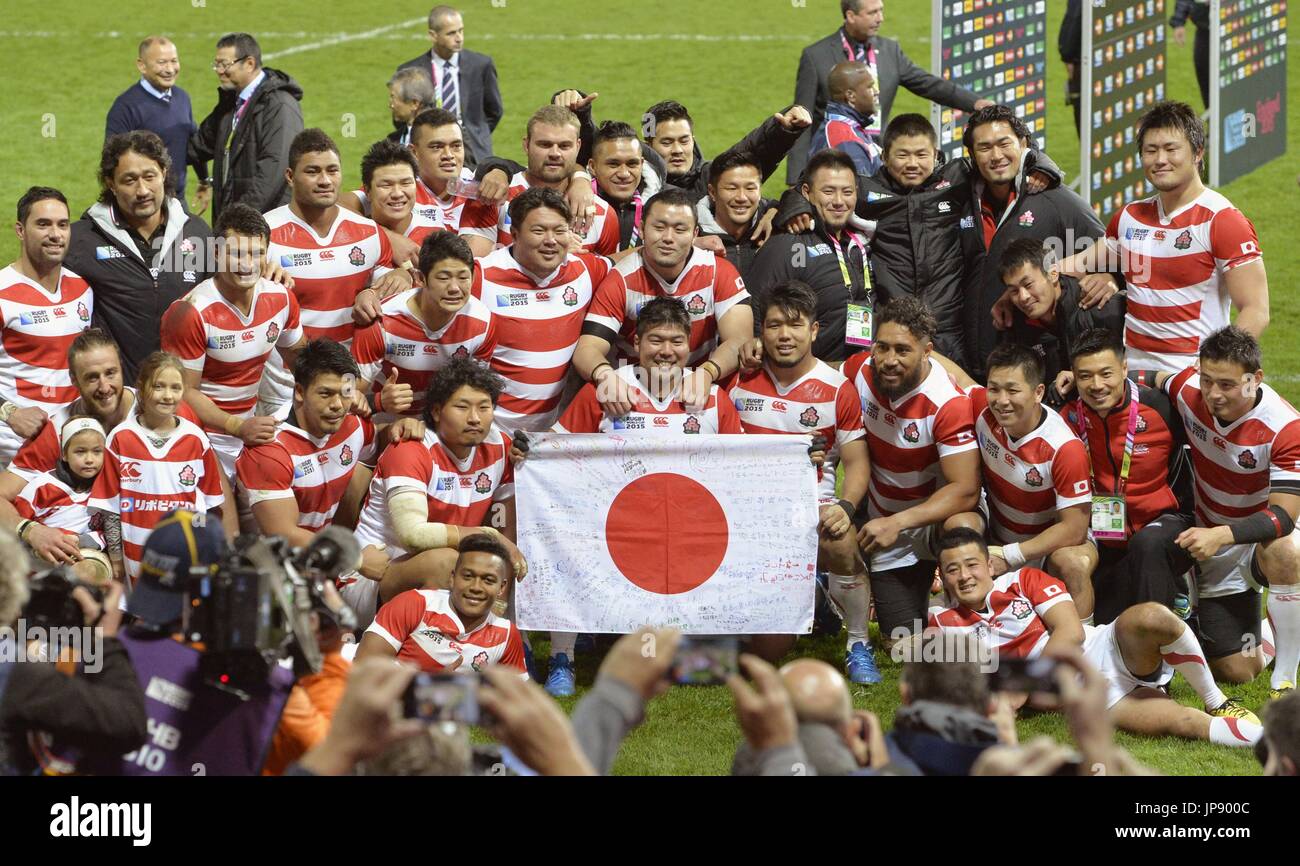 Japan's national rugby team members pose for photos in Gloucester, England,  on Oct. 11, 2015, after beating the United States 28-18 to end with a 3-1  win-loss record in the pool stage
