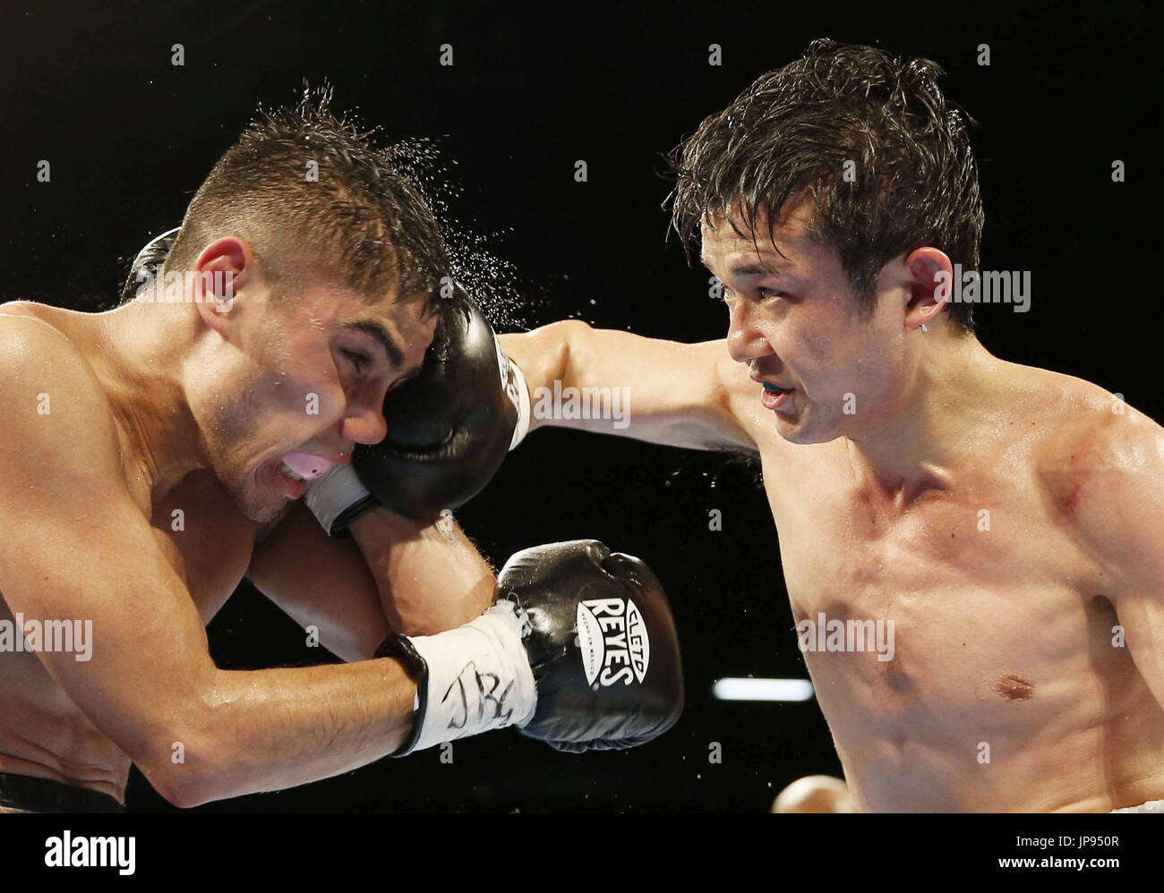 Challenger Yu Kimura of Japan lands a punch on champion Pedro Guevara ...