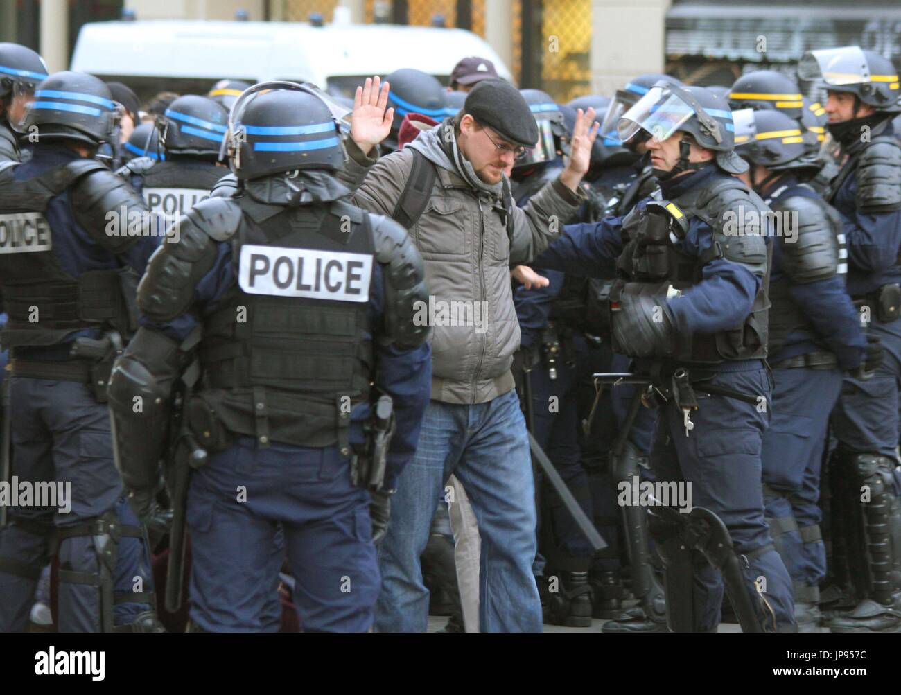 Riot Man A man (C) is detained by riot police at the Place de la Republique ...