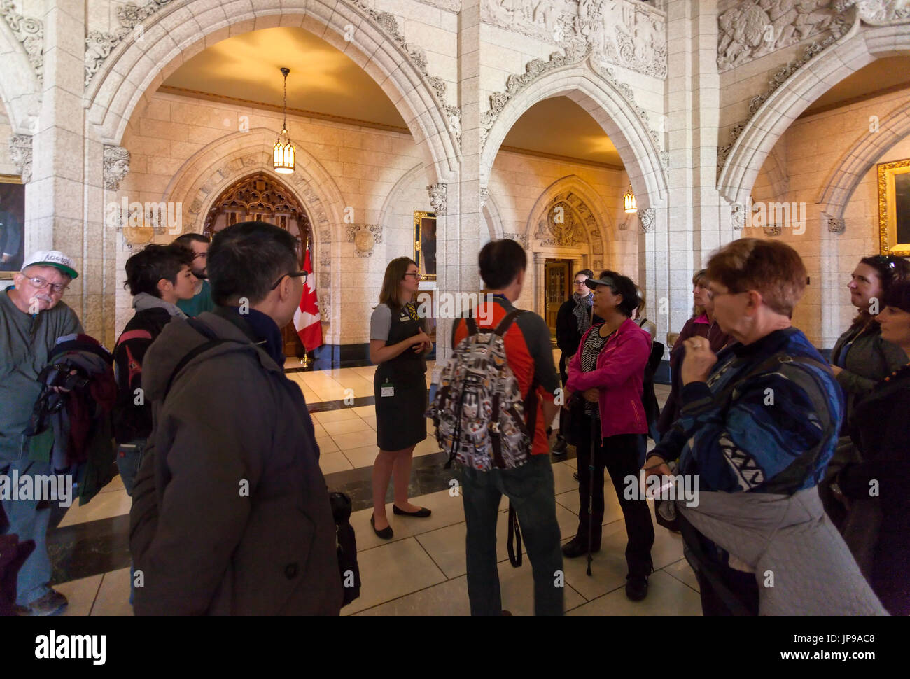 A tour group in the House of Commons Foyer inside the Centre Block the main building of the Canadian parliamentary complex on Parliament Hill. Ottawa. Stock Photo