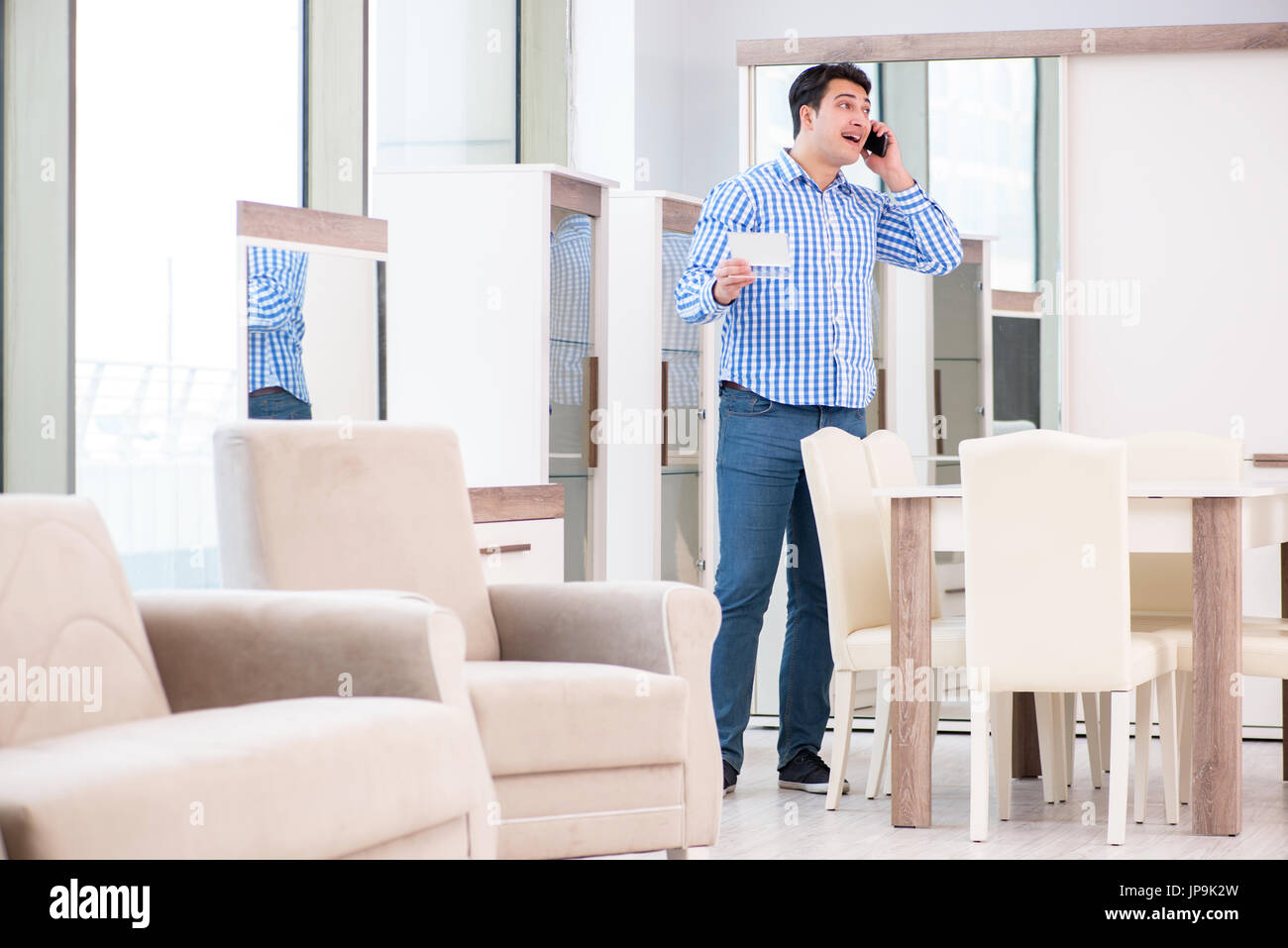 Young man shopping in furniture store Stock Photo - Alamy