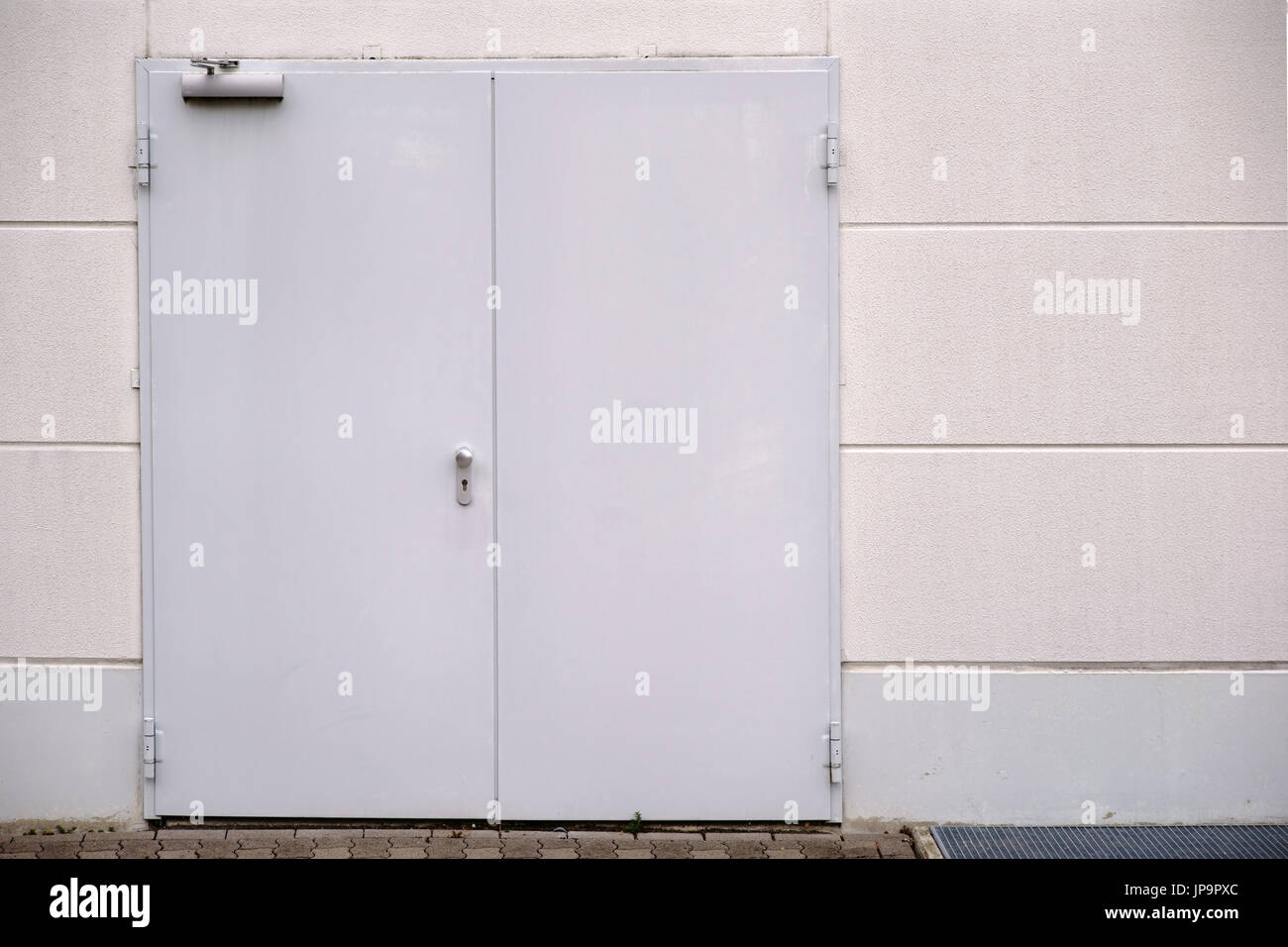 A sidewall of a shopping center with an emergency exit. Stock Photo