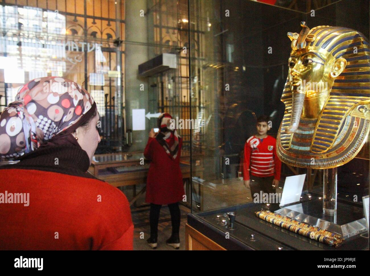 A Visitor Looks At The Restored Gold Mask Of King Tutankhamun At The ...