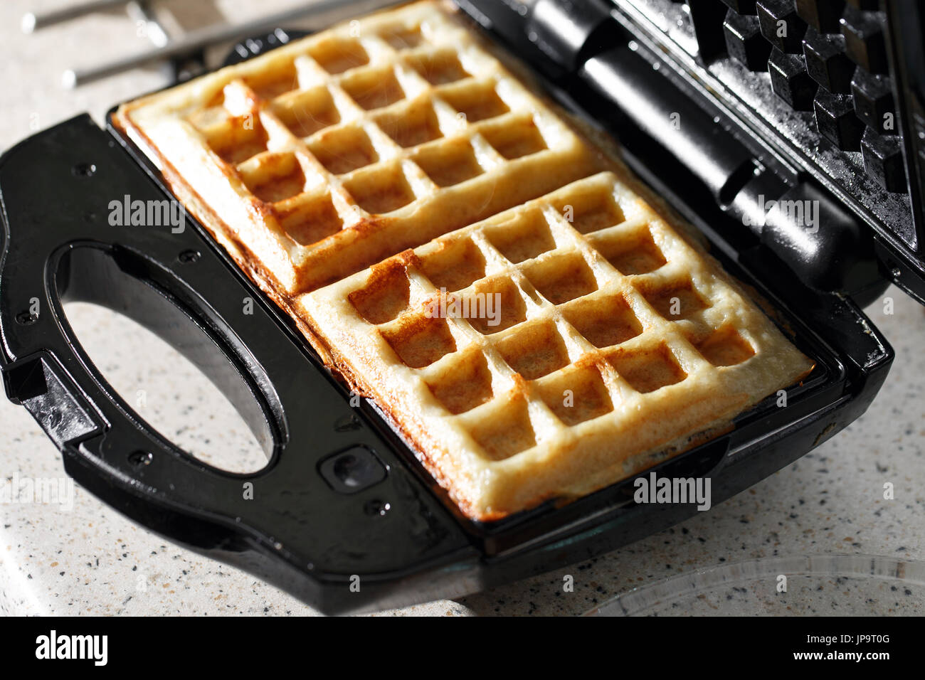 hash browns made in waffle maker kitchen hack Stock Photo - Alamy