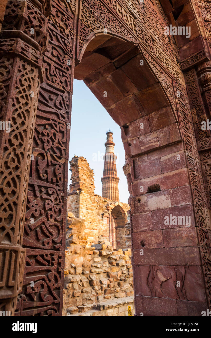 Qutb Minar framed by a cusped archway in the Qutb Complex ruins, Delhi, India. Stock Photo