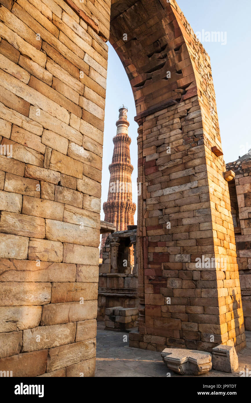 The famous Qutb Minar in Delhi, India seen through an archway in the Qutb Complex, a UNESCO World Heritage Site. Stock Photo