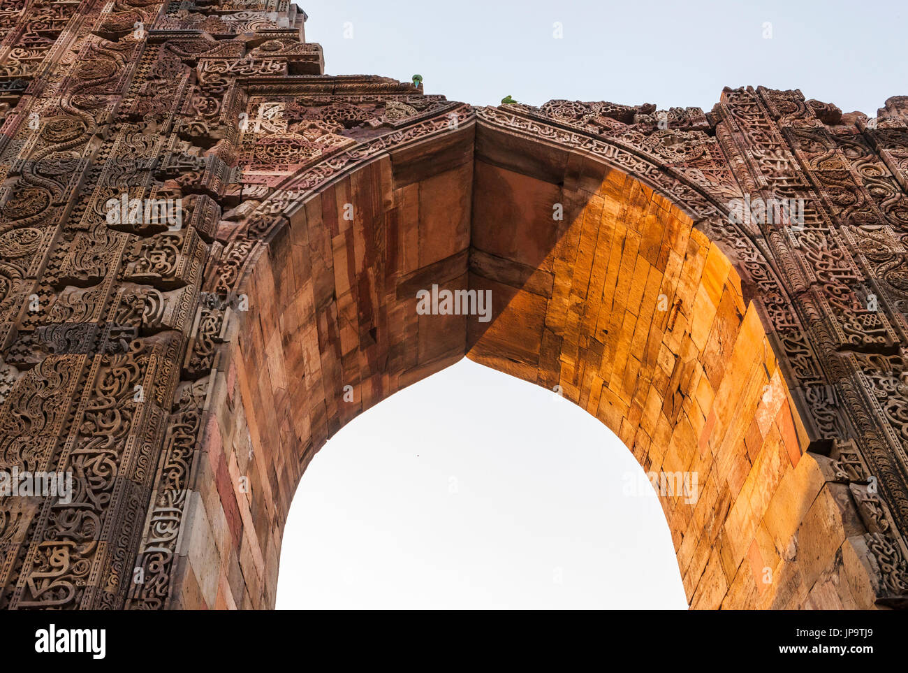 The carved stone arches and walls of the ruins at Qutb Complex in Delhi, India. Stock Photo