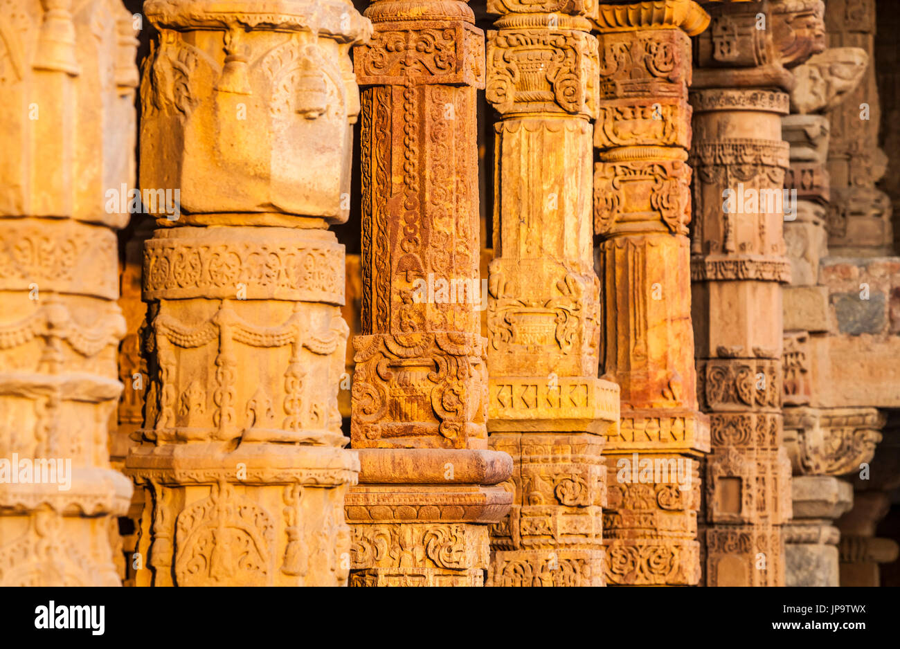 A line of ornate stone columns in the Qutb Complex, Delhi, India. Stock Photo