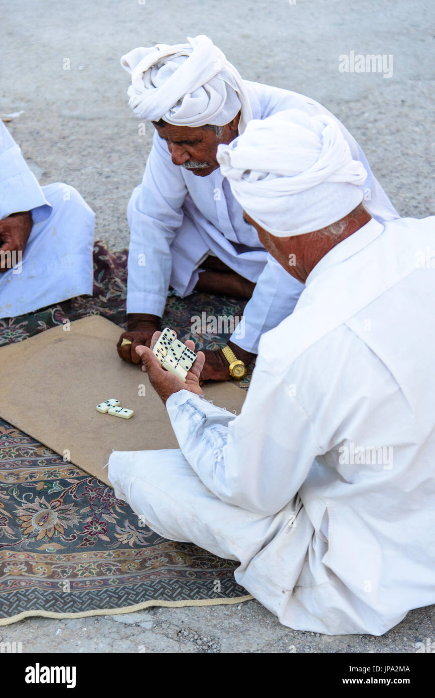 QUESHM ISLAND, IRAN - OCTOBER 25, 2014: Iranian fishermen playing domino Stock Photo