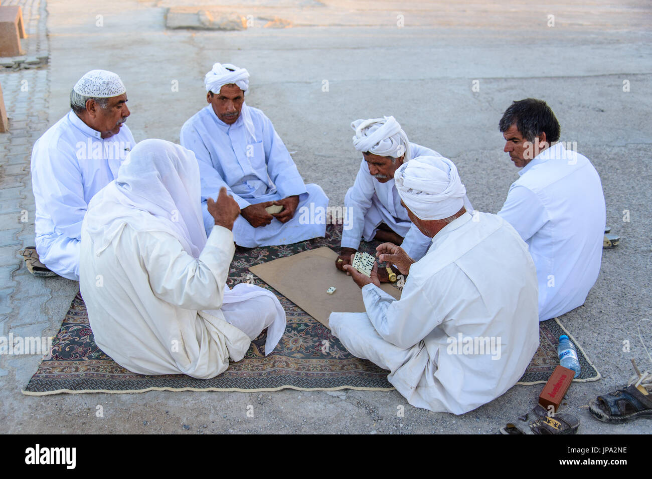 QESHM ISLAND, IRAN - OCTOBER 25, 2014: Iranian fishermen playing domino Stock Photo