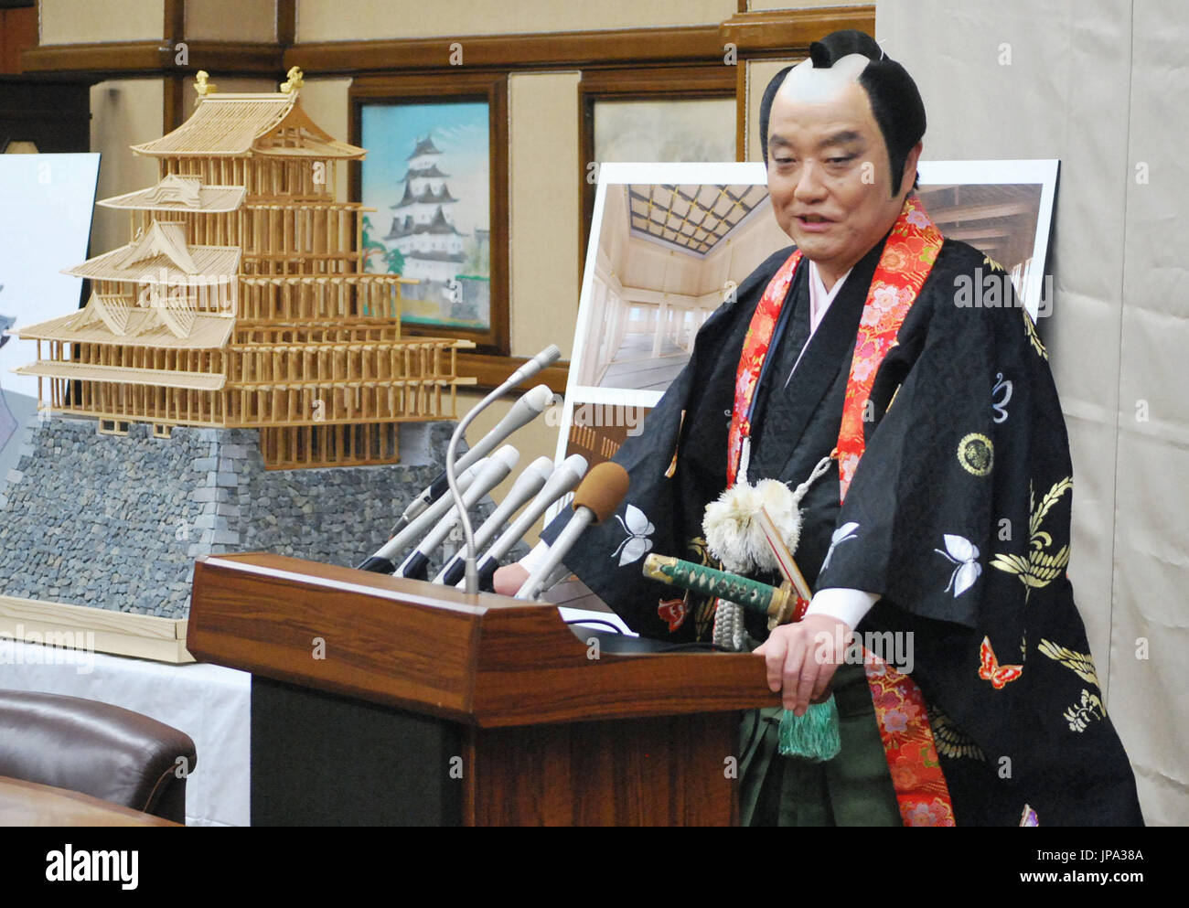 Wearing the topknot, Nagoya Mayor Takashi Kawamura attends a press