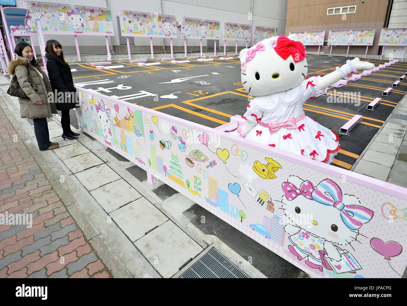 A carparking space decorated with panels featuring Hello Kitty opens