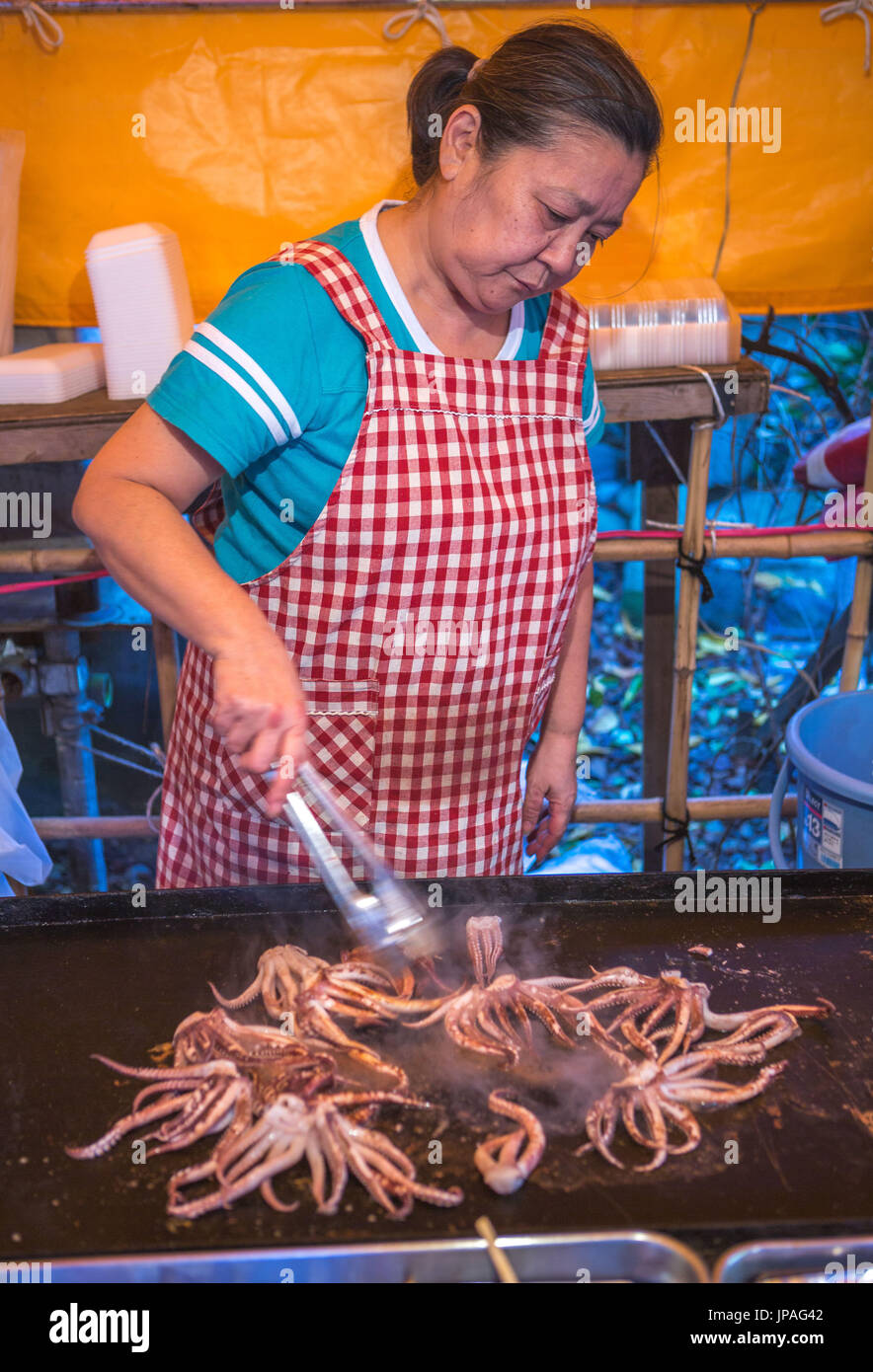 Japan, Tokyo City, Shinjuku district, food stand, Cooking squid, Taco yaki, Stock Photo