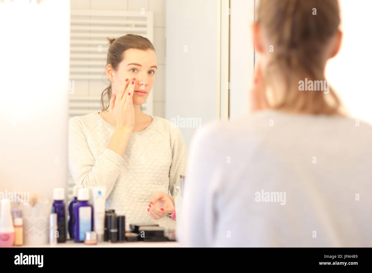 Young woman, mirror image, face, cream, Stock Photo