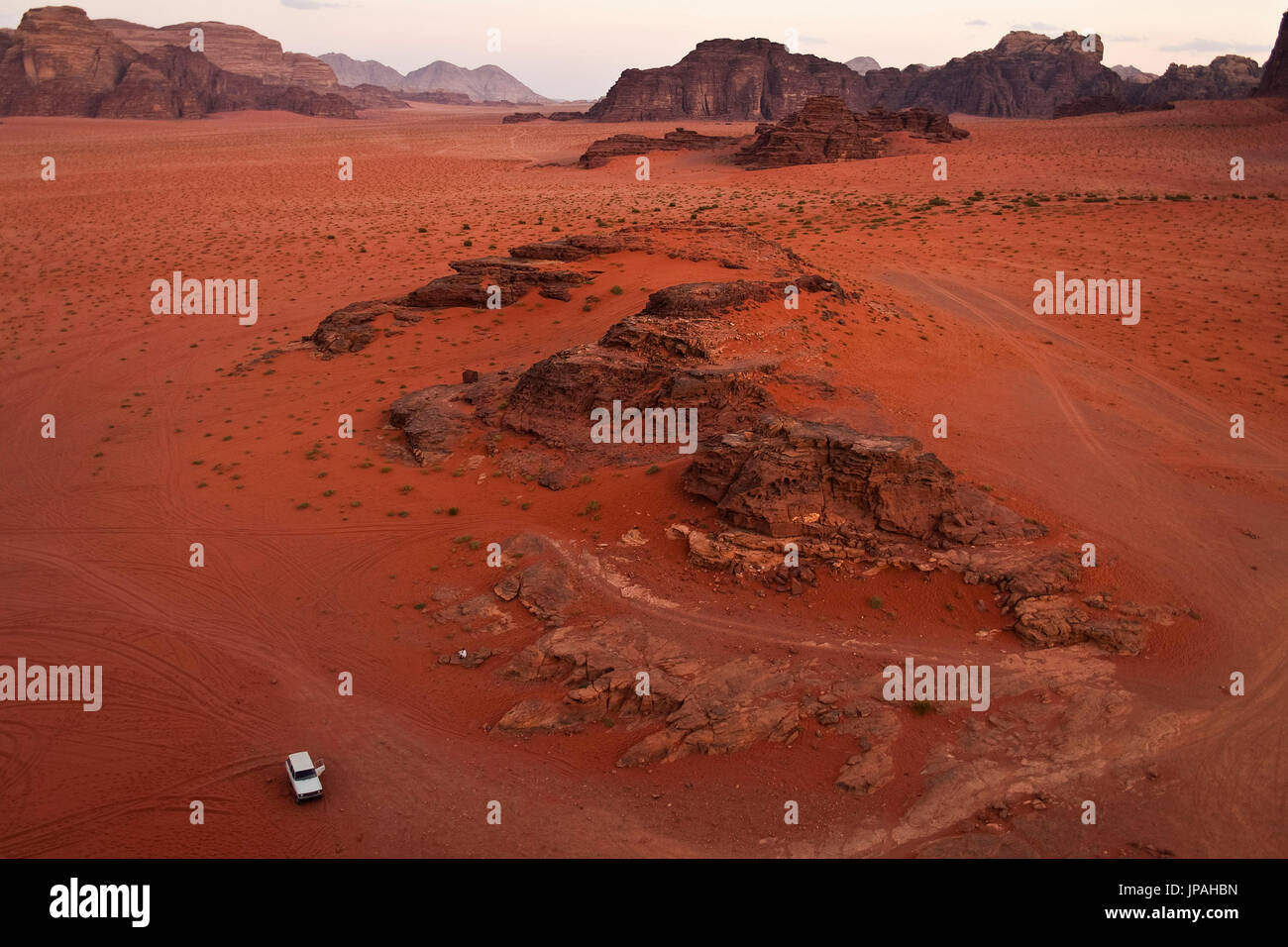 A white jeep parking in the red desert of the wadi rum in Jordan. Stock Photo