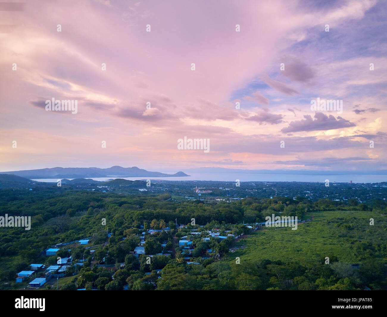 Pink sky over managua city landscape at dusk time aerial view Stock Photo