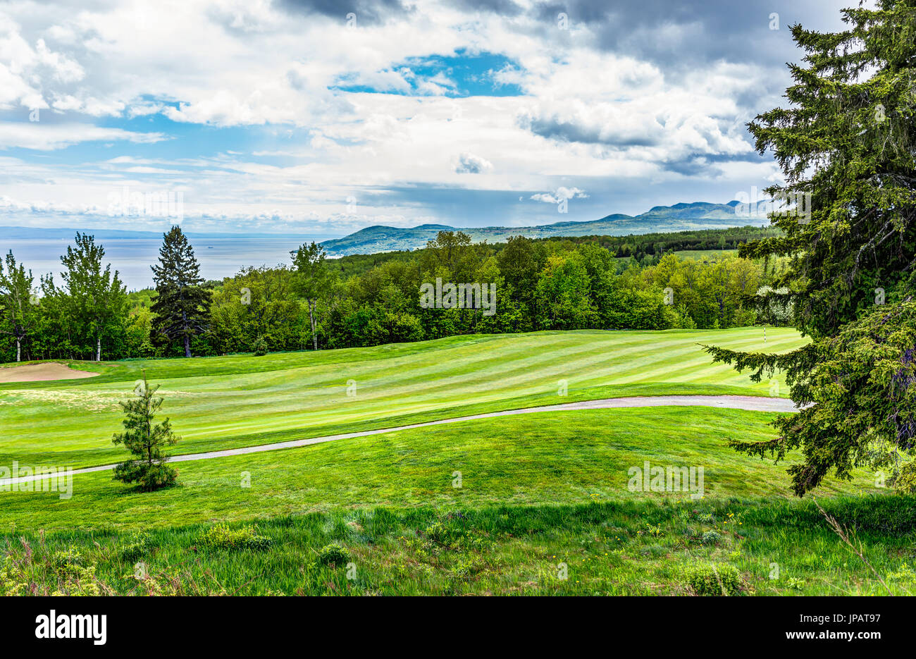 Landscape view of green golf course with hills in summer in La Malbaie