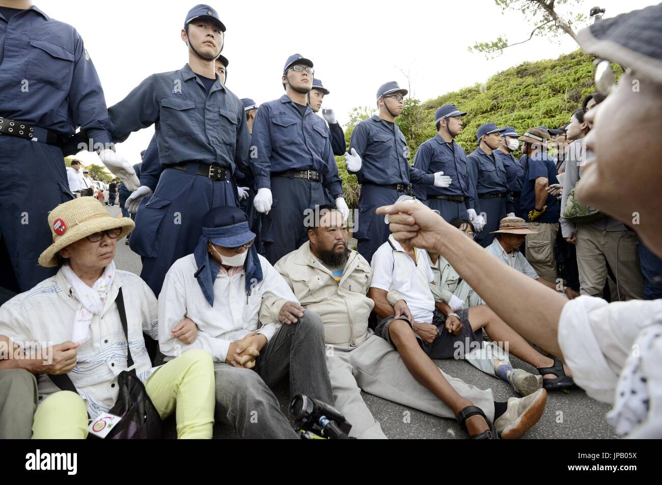 People stage a sit-in protest in front of police officers in the ...